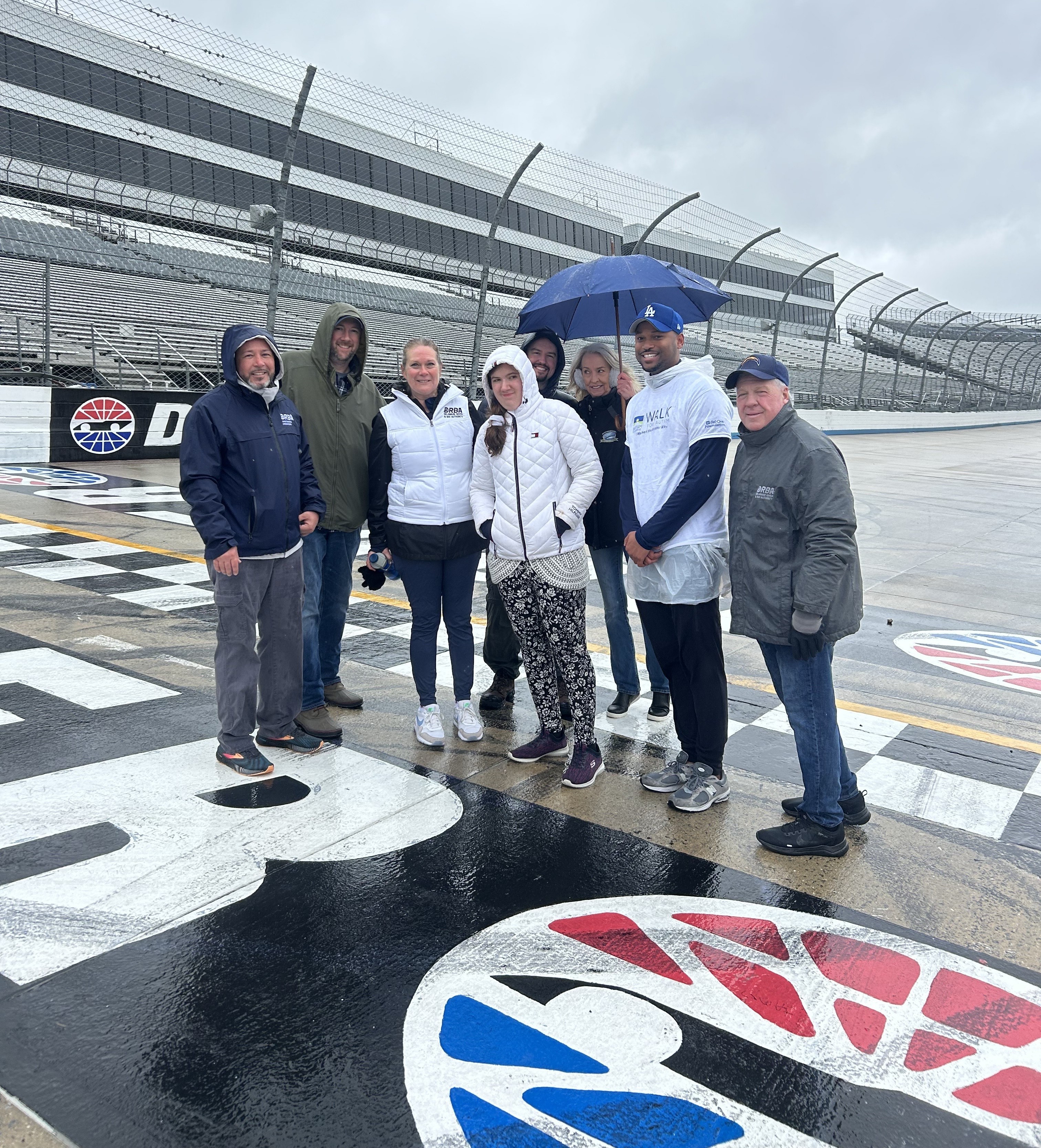 DRBA team poses for a picture on the Dover Motor Speedway for the Delaware Walk for Autism