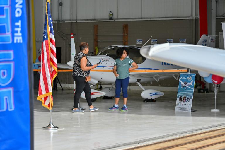 People visit a hangar during Take Flight with AVI at ILG