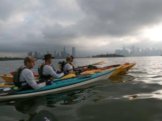 Kayakers for Operation Deep Blue paddle in the NY Harbor