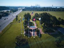 aerial picture of flags around a monument
